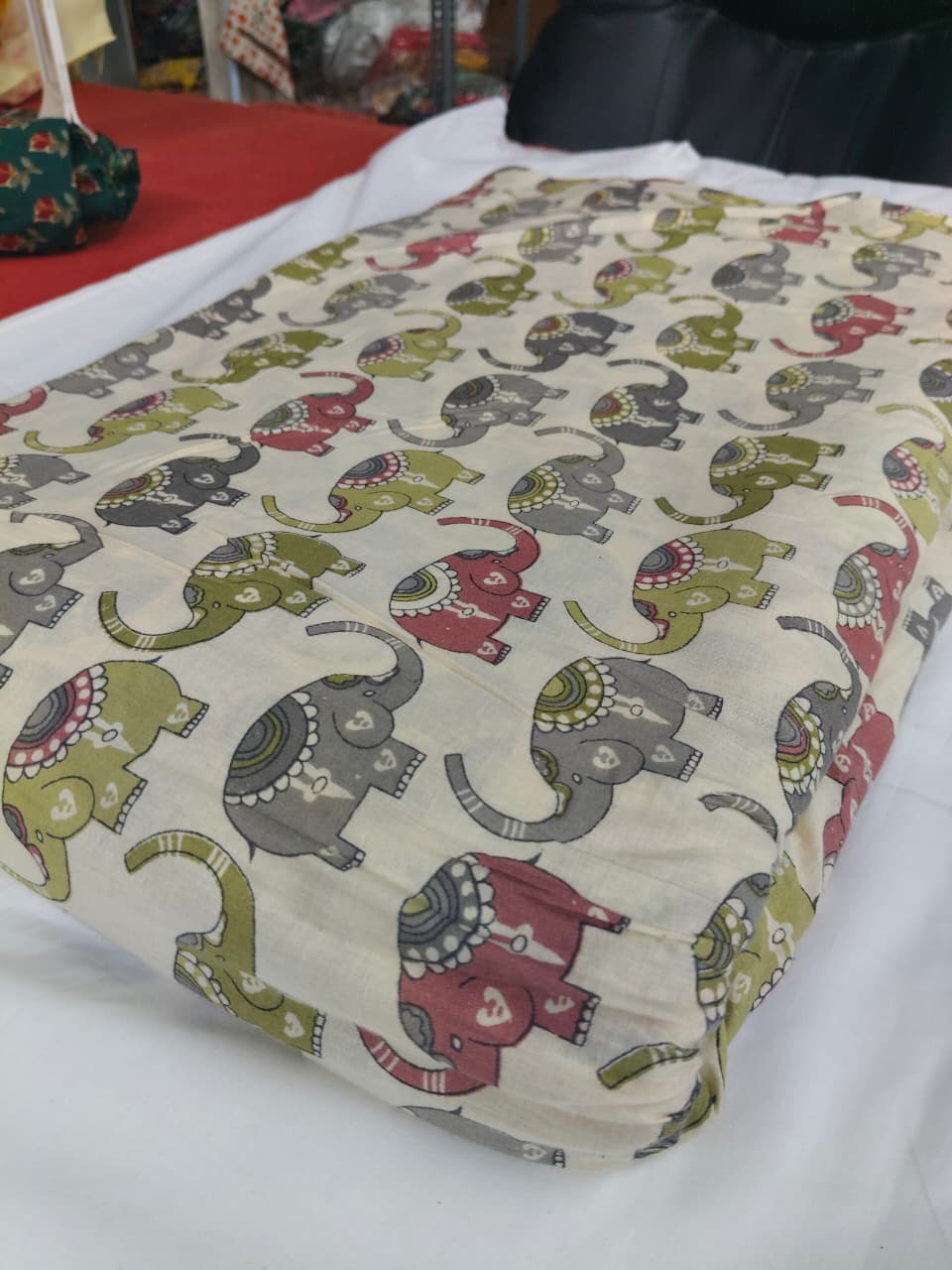 Fabric with colorful elephant pattern on a white surface
