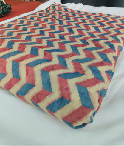 Textile with red and blue zigzag pattern on a white surface
