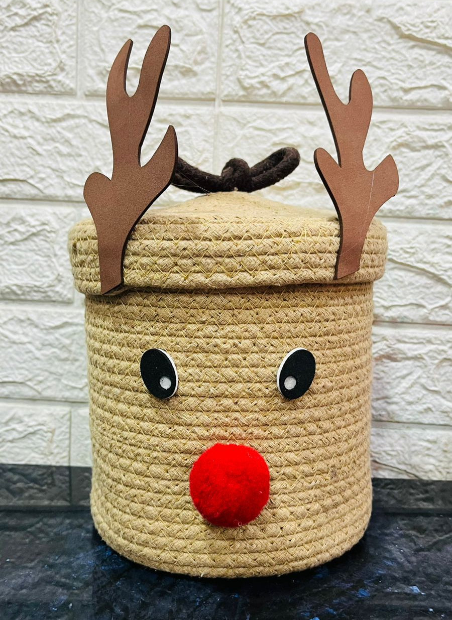 Decorative basket shaped like a reindeer with antlers and a red nose on a stone surface.