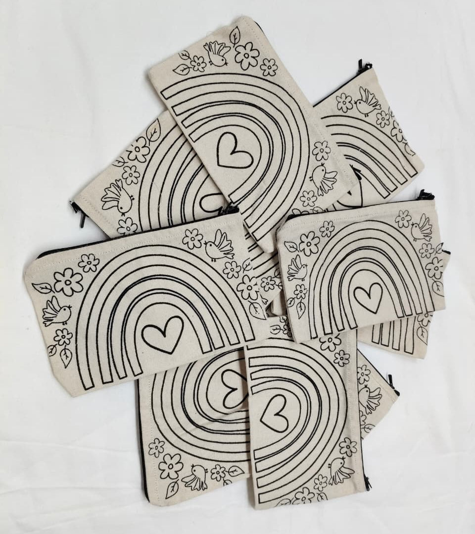 Set of pouches with rainbow and heart designs on a white background