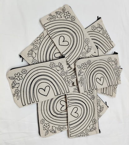 Set of pouches with rainbow and heart designs on a white background